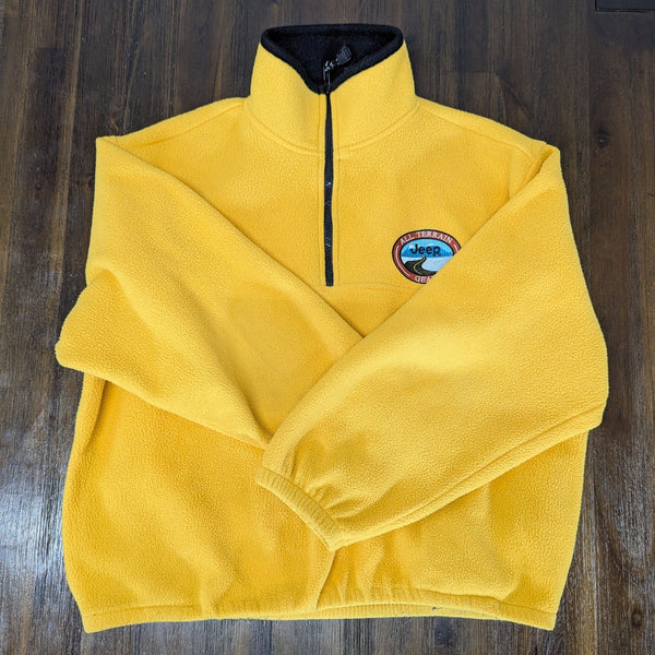 1. Bright yellow Jeep men’s fleece pullover with half-zip and embroidered chest patch, shown from the front.
