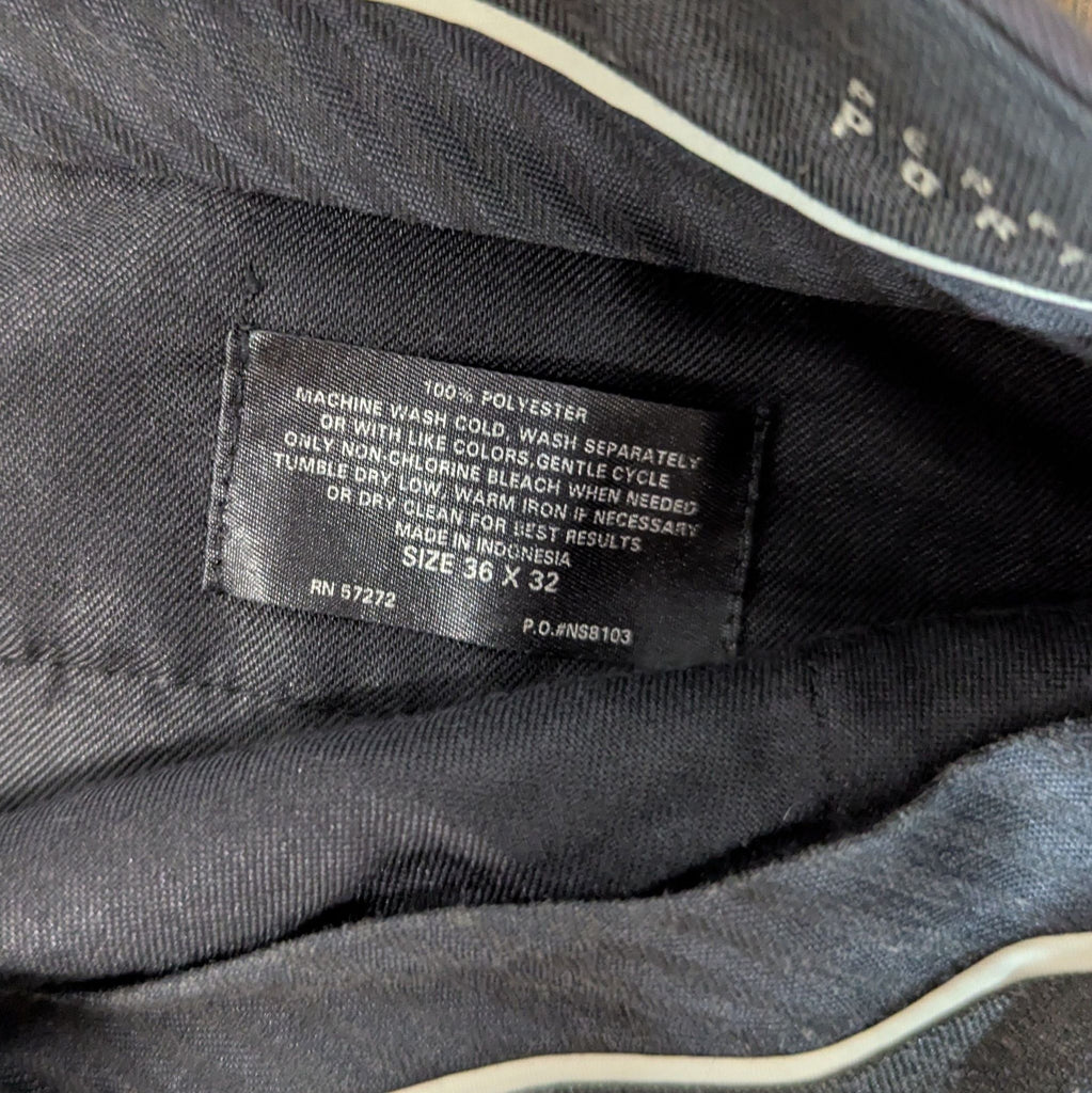 3. Close-up of pants label detailing care instructions, material, and size 36 x 32.