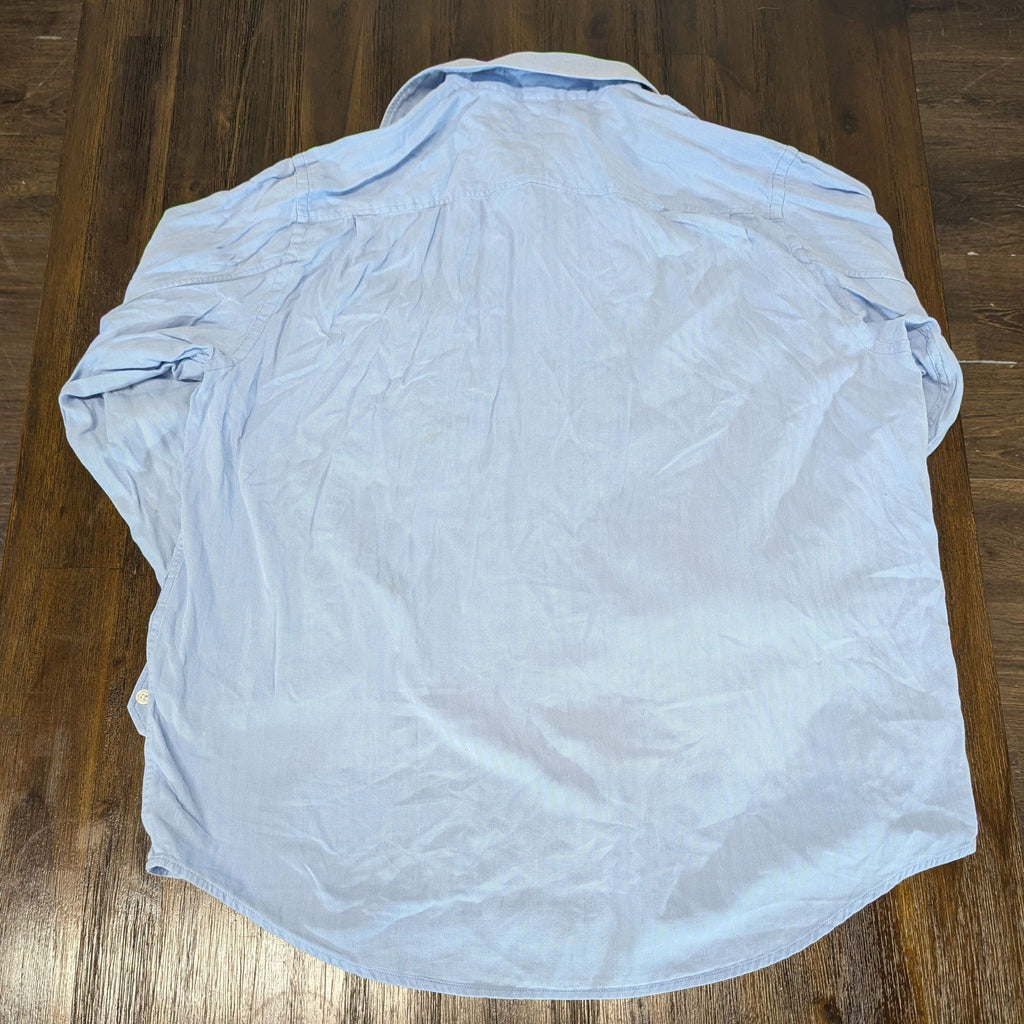 2. Back view of a light blue Merona men's shirt, showing details and wrinkles, laid flat on a table.