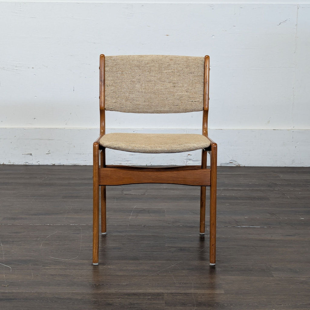 1. Modern wooden dining chair with cushioned seat and slatted backrest, side view.