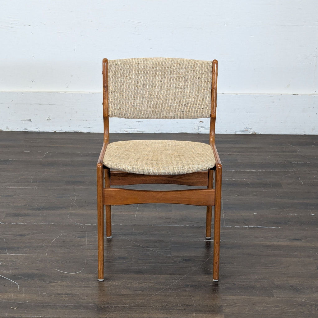 2. Elegant dining chair featuring a fabric-upholstered seat and curved wooden legs.