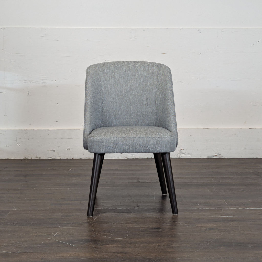 2. Modern Room & Board gray dining chair featuring a rounded back and dark legs, viewed from the front.