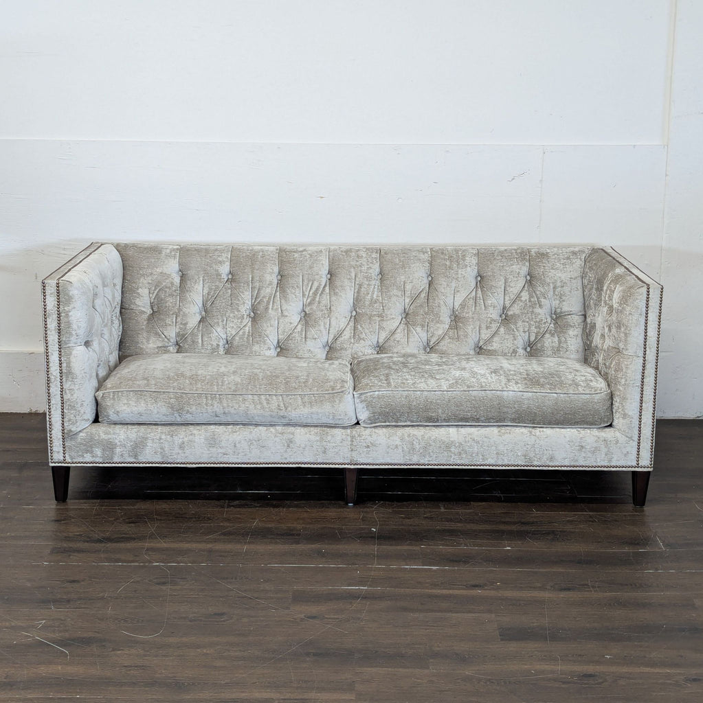 2. Elegant Lexington 3-seat sofa with tufted design, metallic upholstery, and wooden legs, shown against a white wall.  