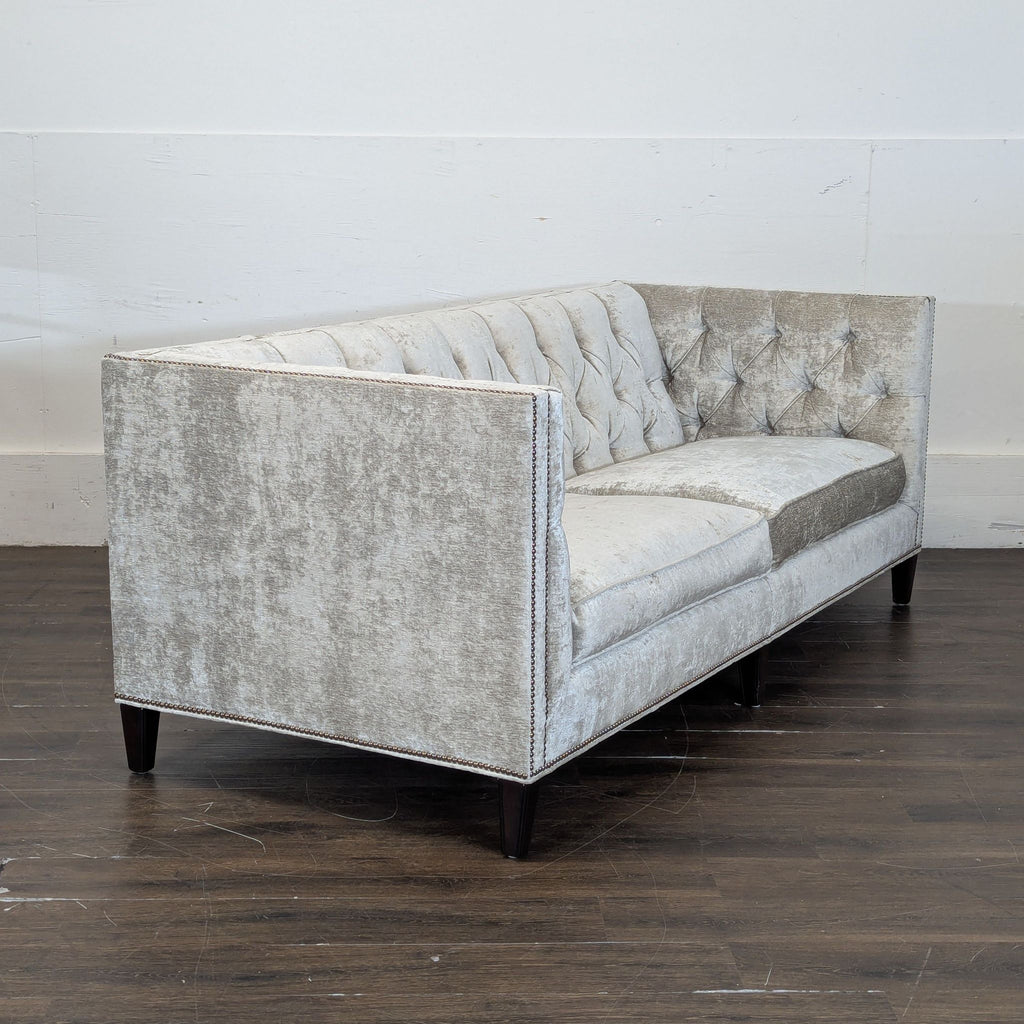 3. Side angle of a Lexington 3-seat sofa in silvery fabric, featuring tufted details and clean, straight armrests.