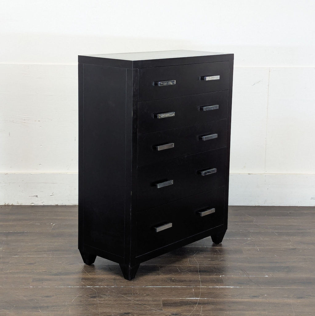 3. Angled view of Pottery Barn black dresser, five drawers with chrome handles, contemporary style.