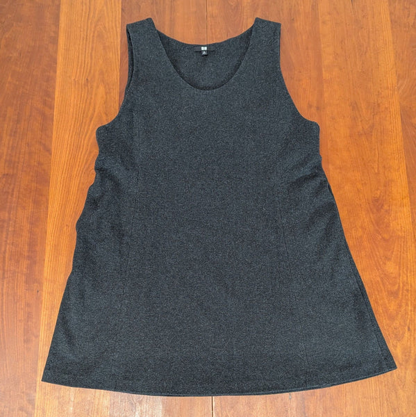 Front view of a sleeveless dark gray Uniqlo women's top laid flat on a wooden surface.  
