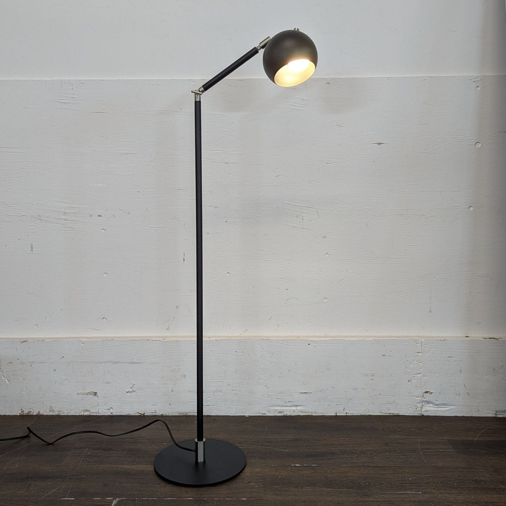 Sleek Room & Board Camber floor lamp featuring a black finish, cylindrical shade, and minimalist design.