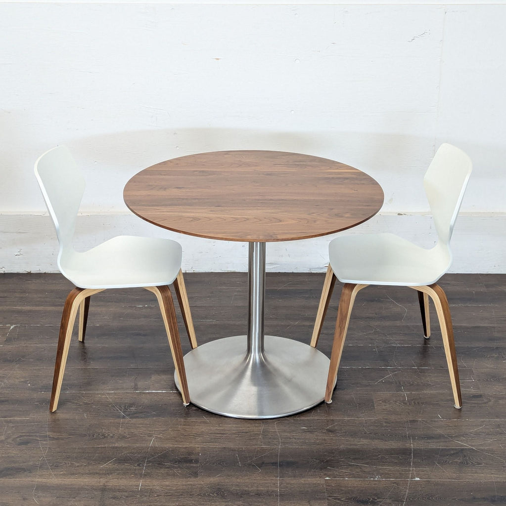 Contemporary dining set featuring a 36" Aria walnut table and two Pike wood chairs from Room & Board.