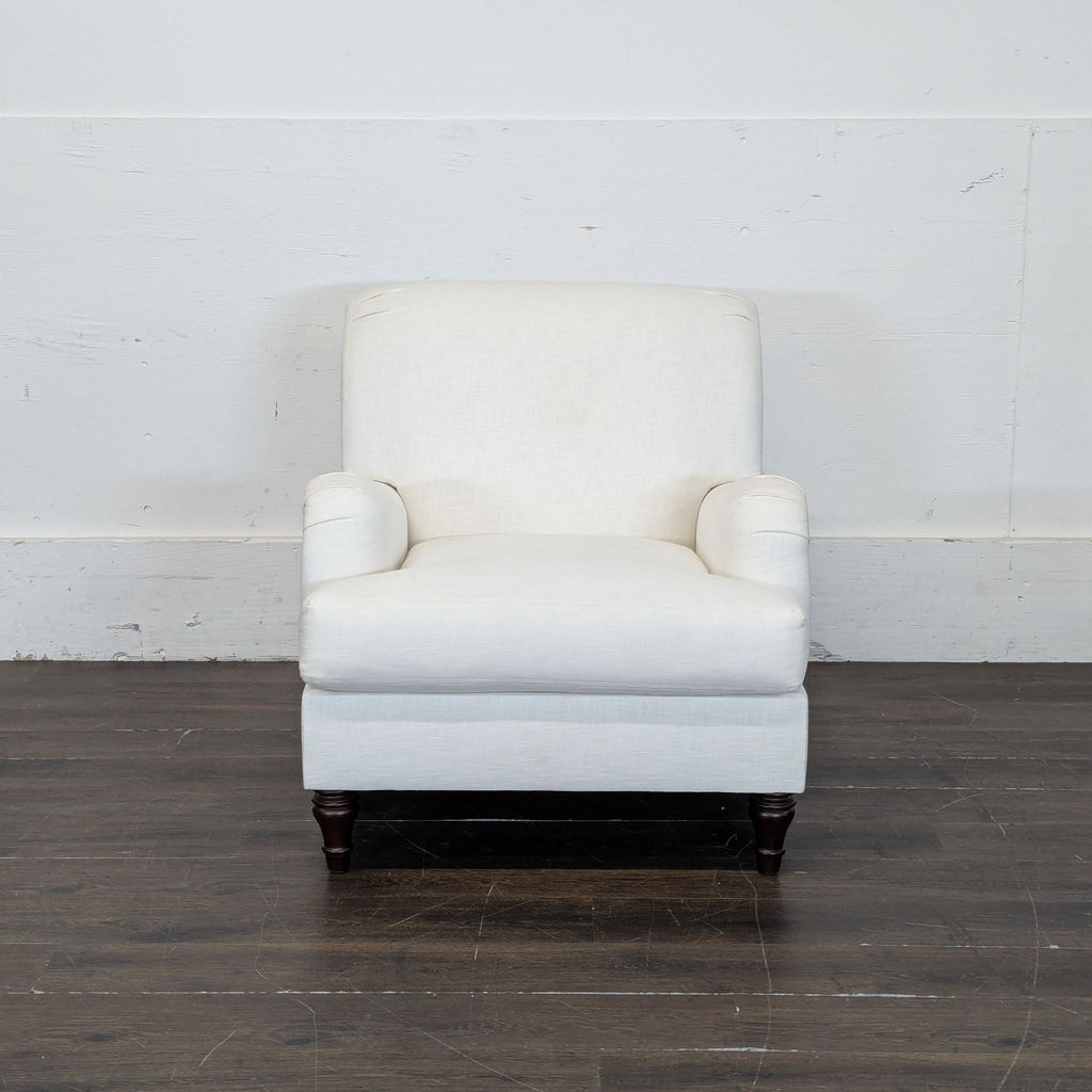 1. Modern lounge chair with a plush cushion and minimalist wooden legs in a cozy setting.