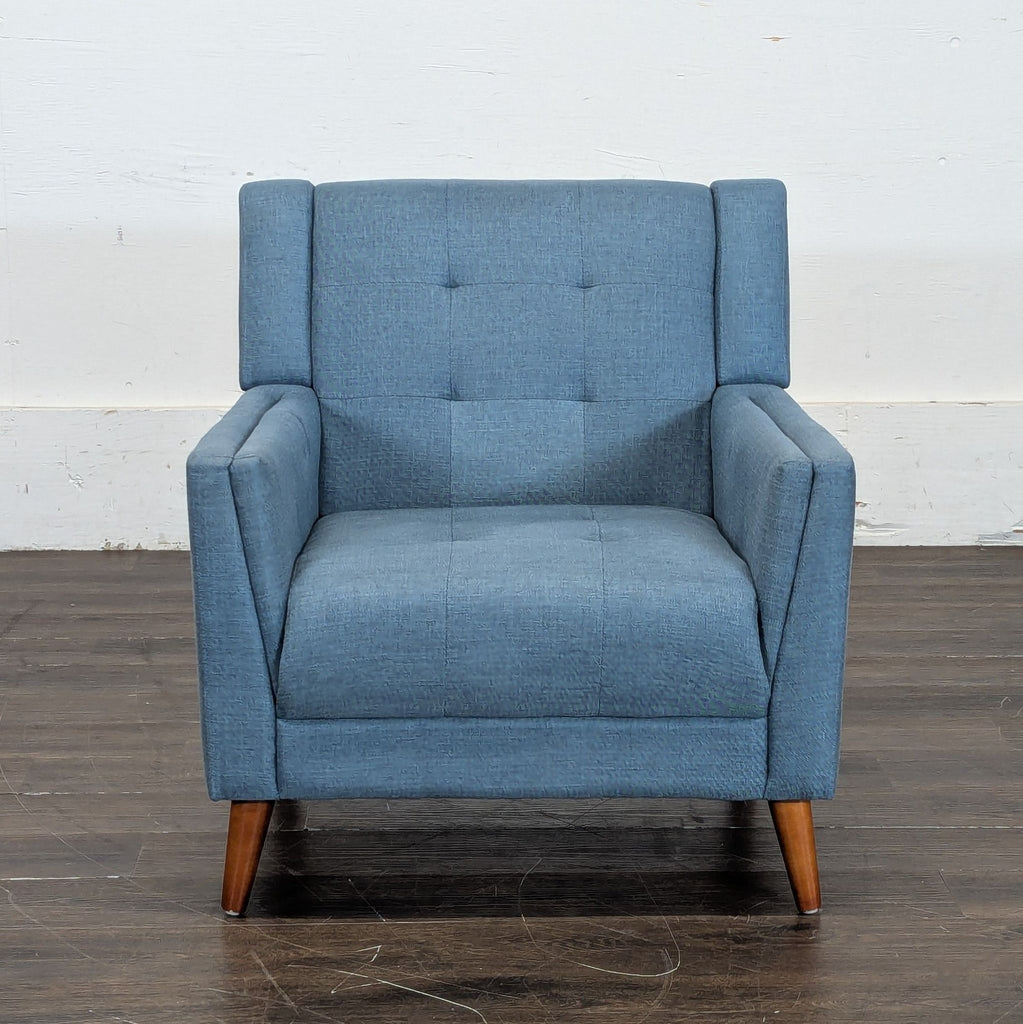 1. Blue upholstered lounge chair with wooden legs, square arms, and a tufted backrest, viewed from the front.