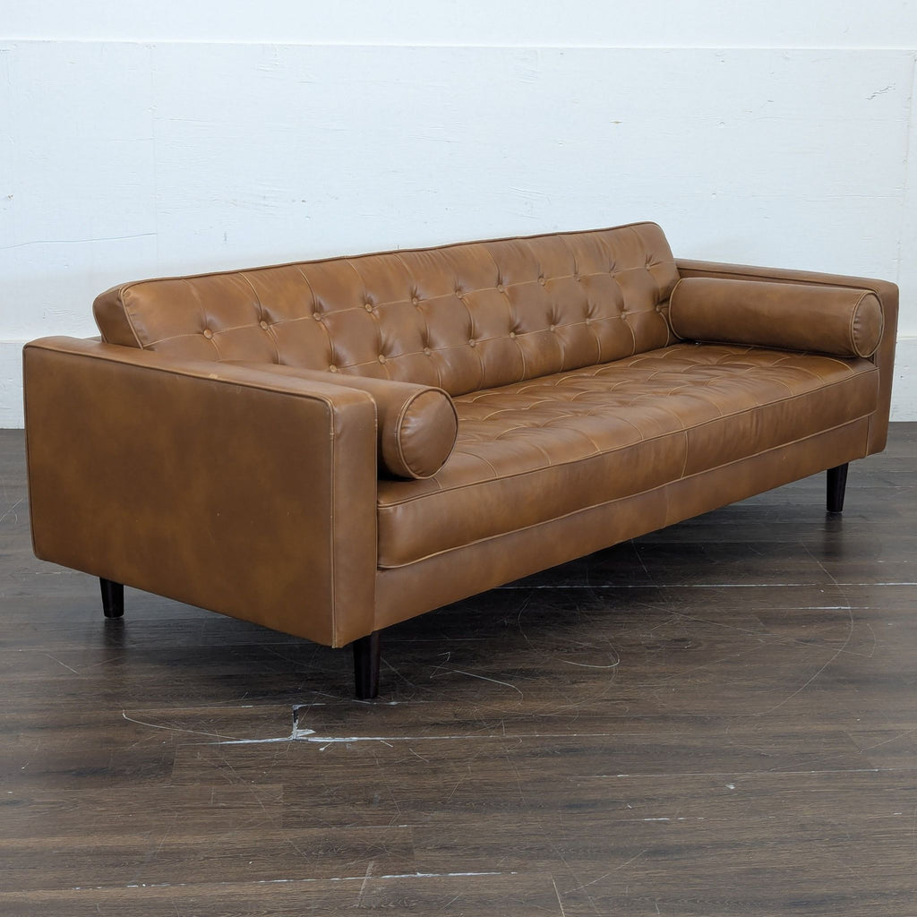 2. Stylish three-seater couch with wooden legs, designed for both comfort and elegance.