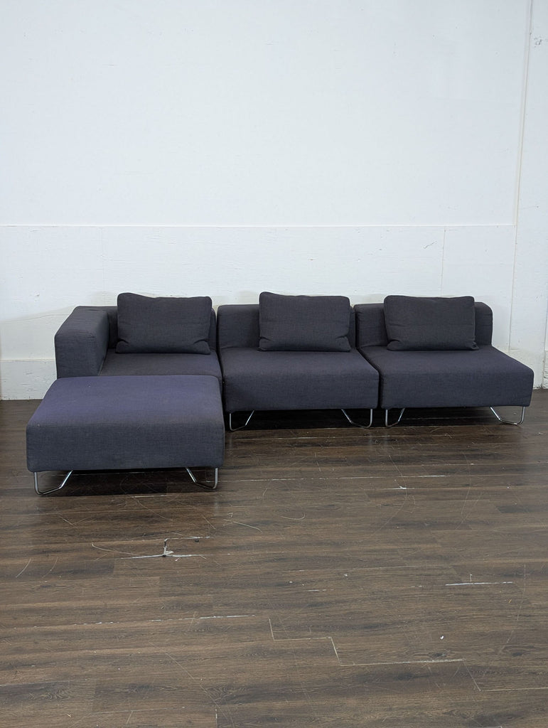 1. Contemporary L-shaped sectional sofa with fabric upholstery and chaise lounge extension.