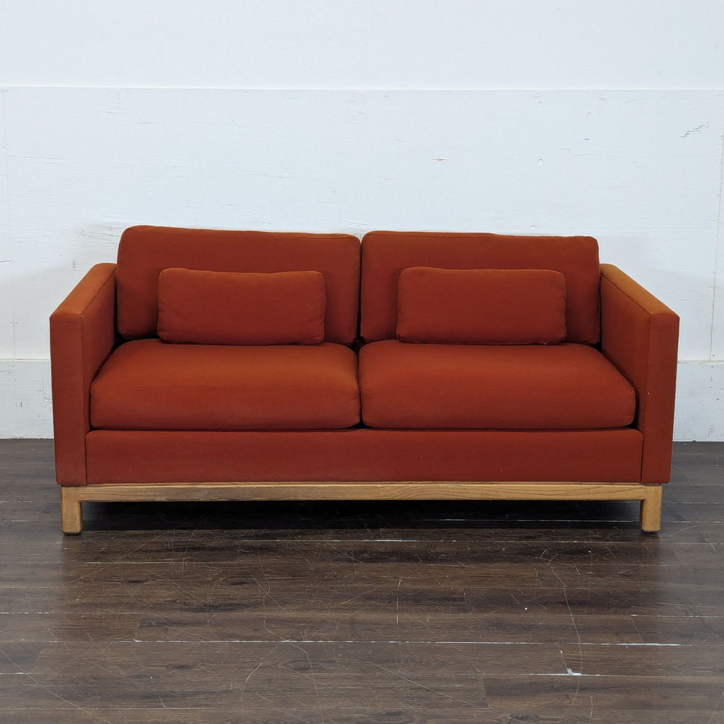 1. Modern gray fabric loveseat with tufted cushions and wooden legs, seating two people.