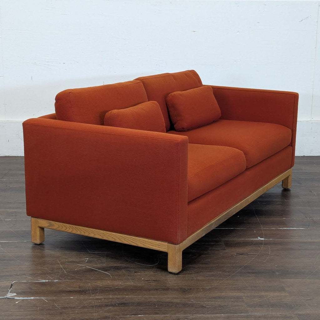 2. Compact loveseat in soft beige upholstery, ideal for small living room spaces.
