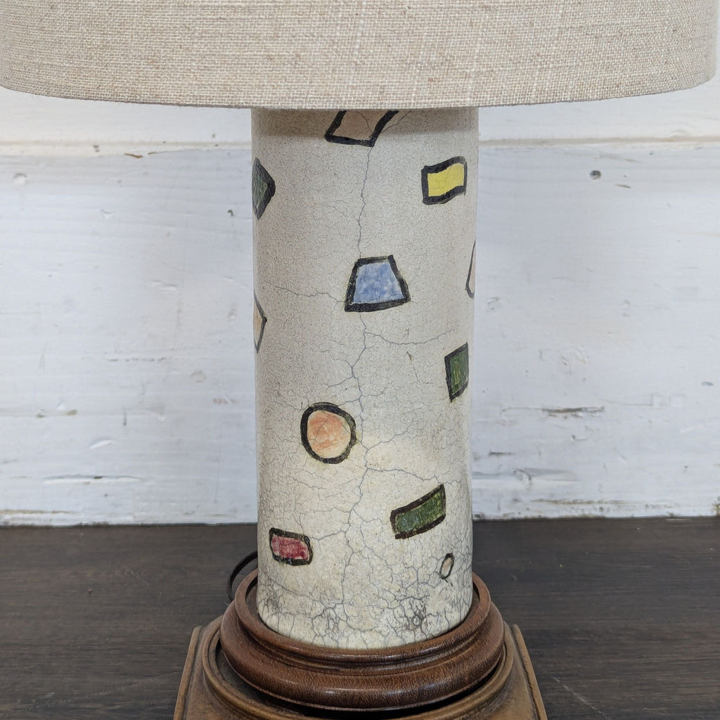 2. Close-up of lamp base shows textured ceramic decorated with crackle finish and multi-colored geometric designs.