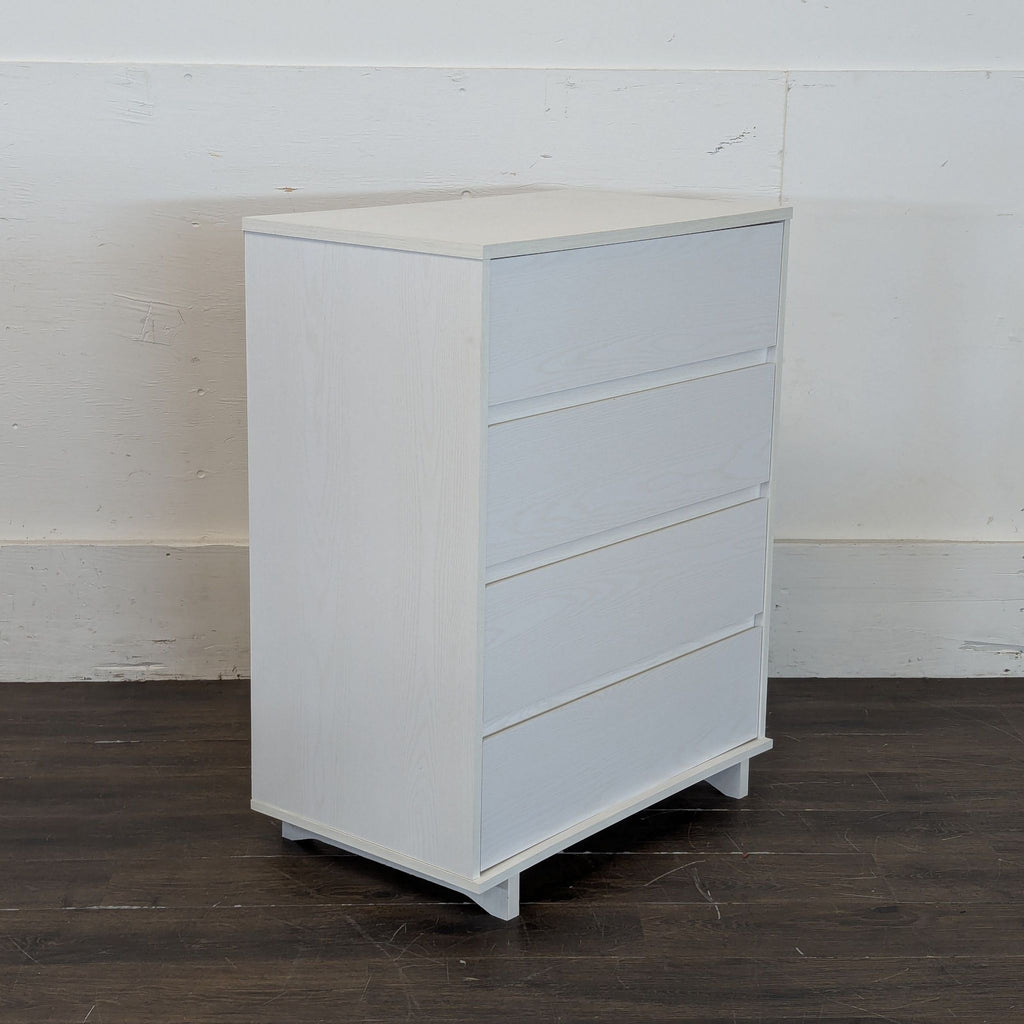 3. Side angle of a sleek white four-drawer Target dresser, showcasing its compact and modern design.