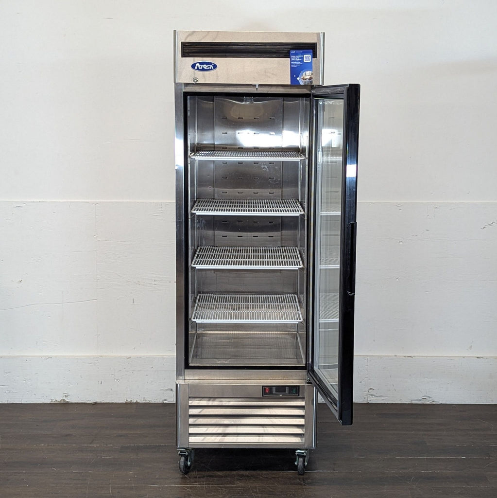 2. Atosa upright refrigerator with glass door open, four wire shelves, stainless steel design, on wheels.
