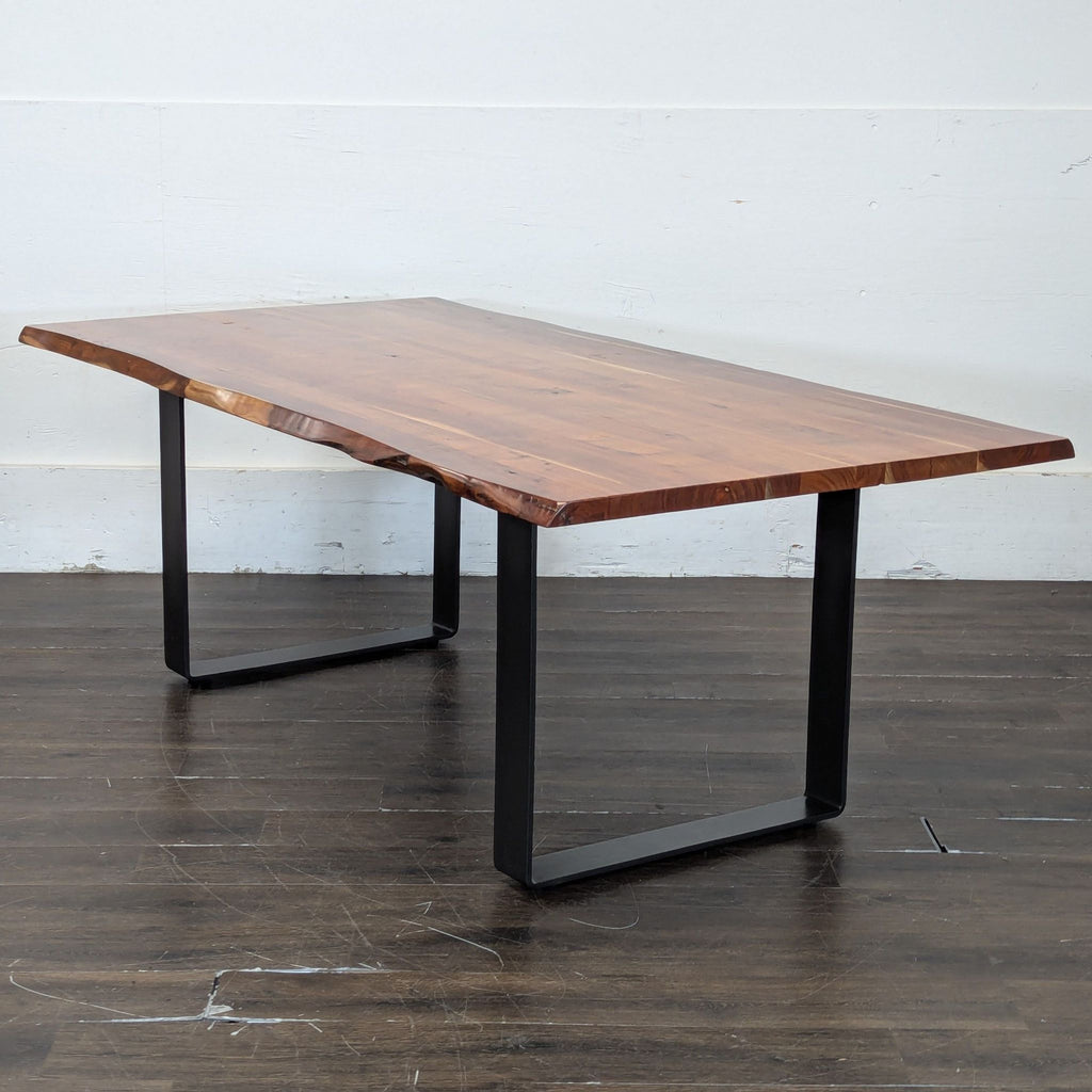 3. Side angle view of a live edge wooden dining table with black metal legs, highlighting the natural wood grain.