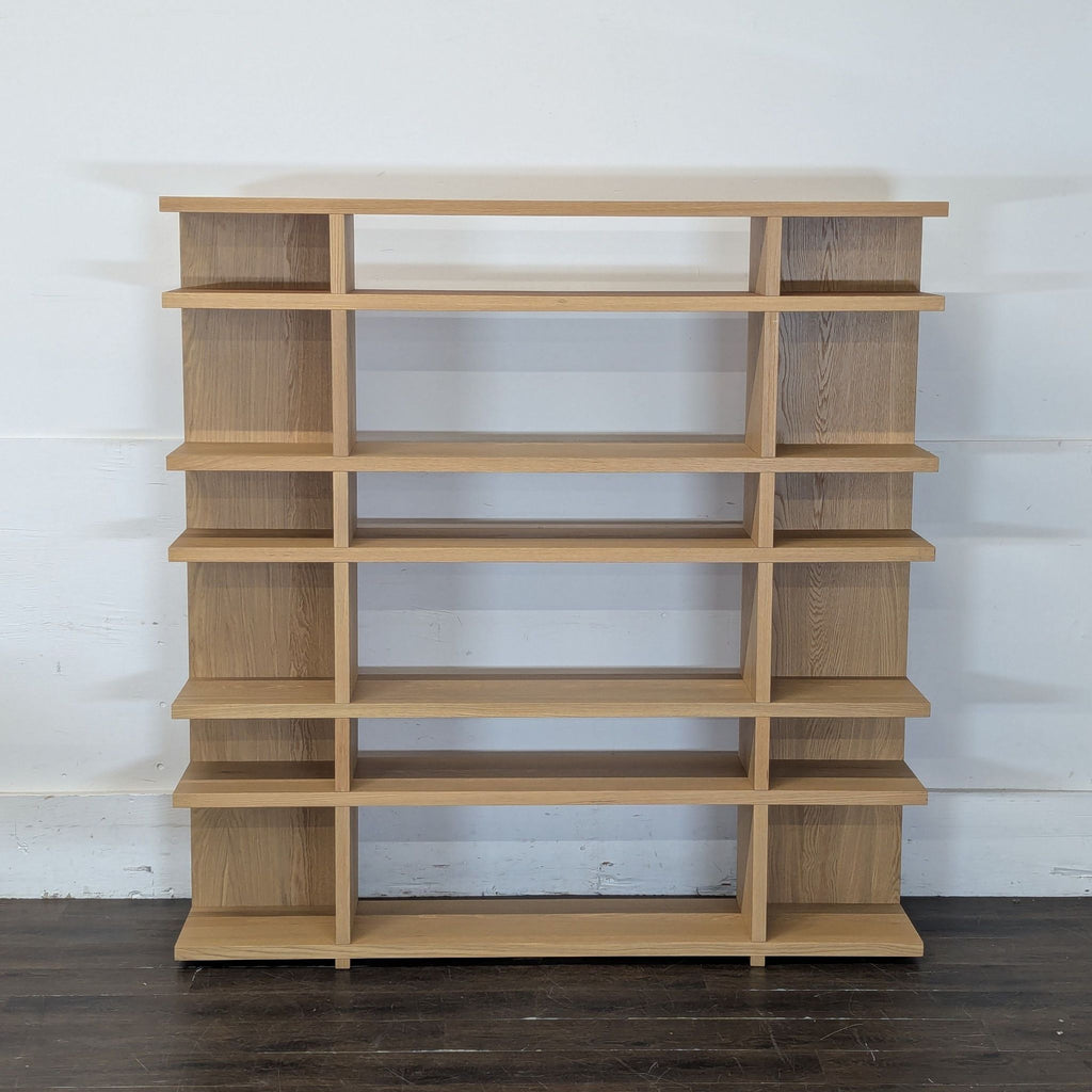 2. Modern white bookshelf filled with a mix of colorful books and green houseplants.  