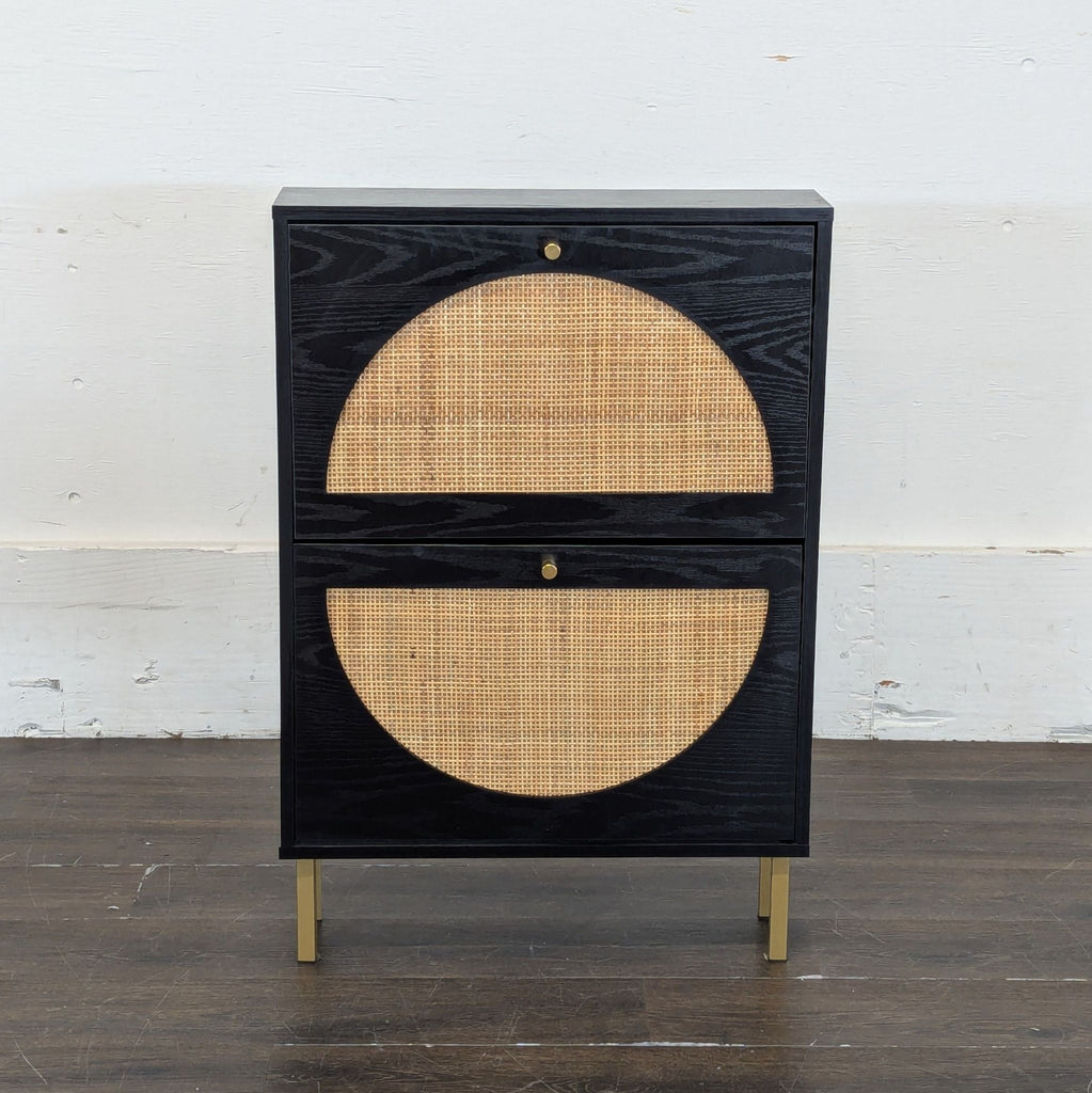 2. Modern black cabinet with rattan semi-circle panels and brass legs, set against a plain white wall.
