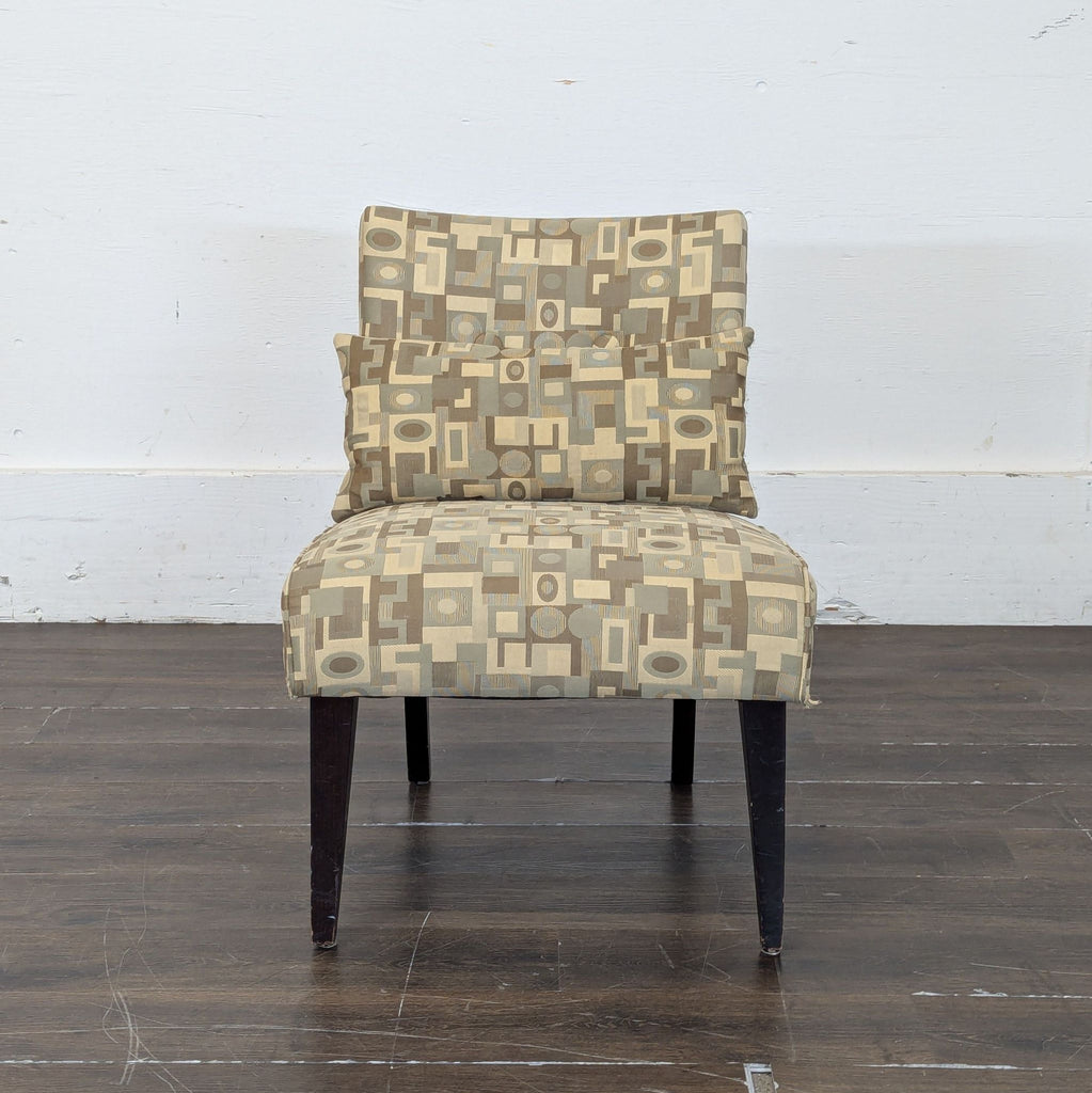 2. Modern lounge chair from Crate & Barrel, featuring abstract patterned fabric in neutral tones and a rectangular cushion.
