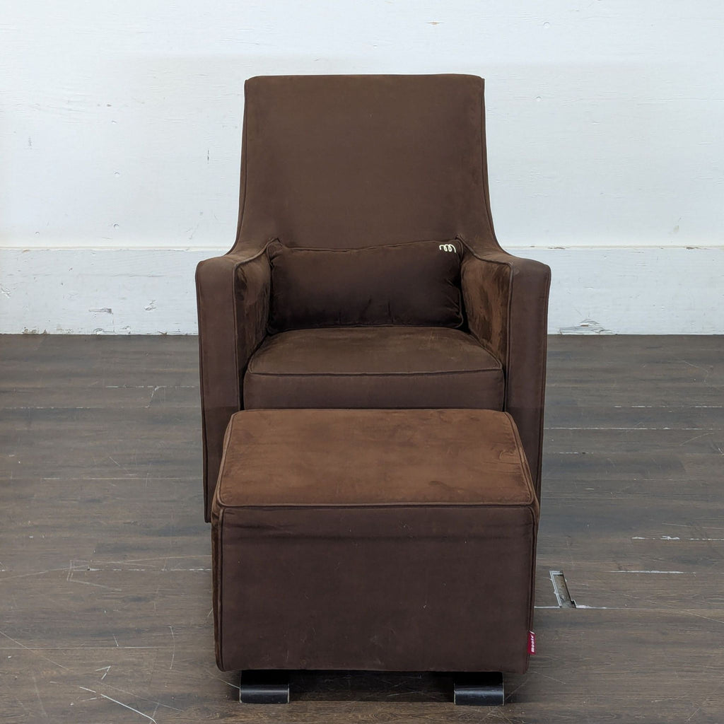 A brown Monte lounge chair with armrests, lumbar cushion, and matching ottoman on a wooden floor.  