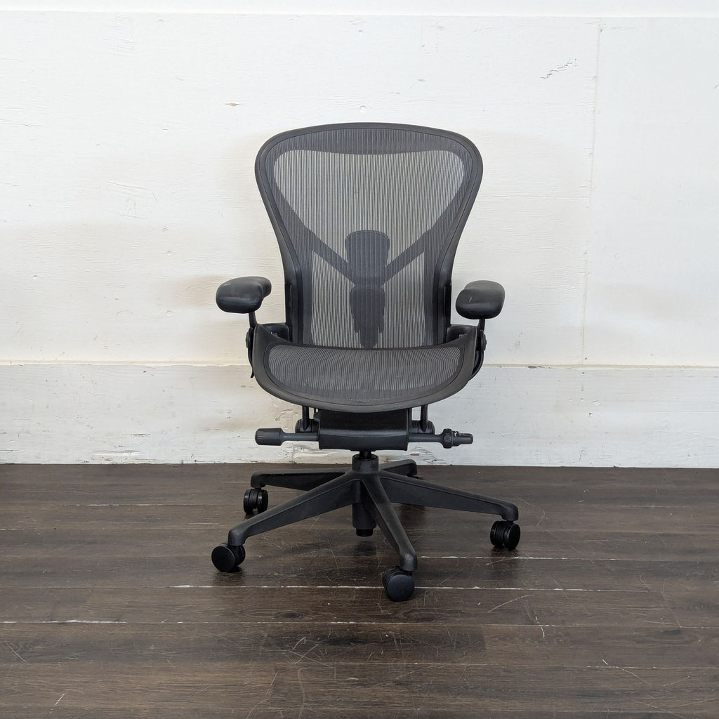 Side view of a gently used black Aeron office chair (set of 2), modern styling, office furniture.  