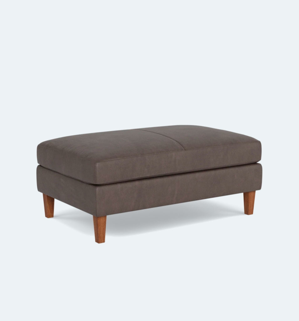 a modern ottoman with a dark brown fabric.