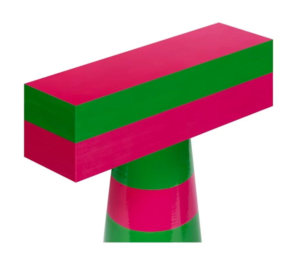 a green and white frosted cake sitting on top of a red and white stripe 