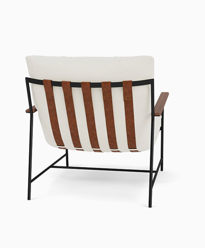 3. Rear view of the Reperch lounge chair highlighting wide brown leather straps and white padded back.