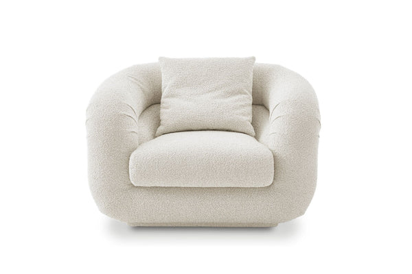 1. Front view of a plush, cream-colored lounge chair by Castlery with rounded arms and a matching pillow.