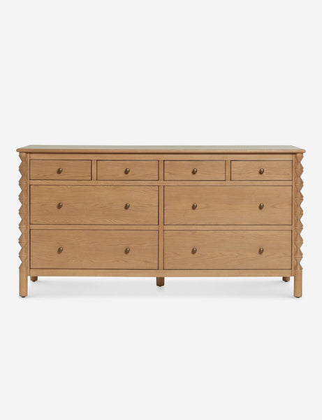 a large chest of drawers with a light wood finish.