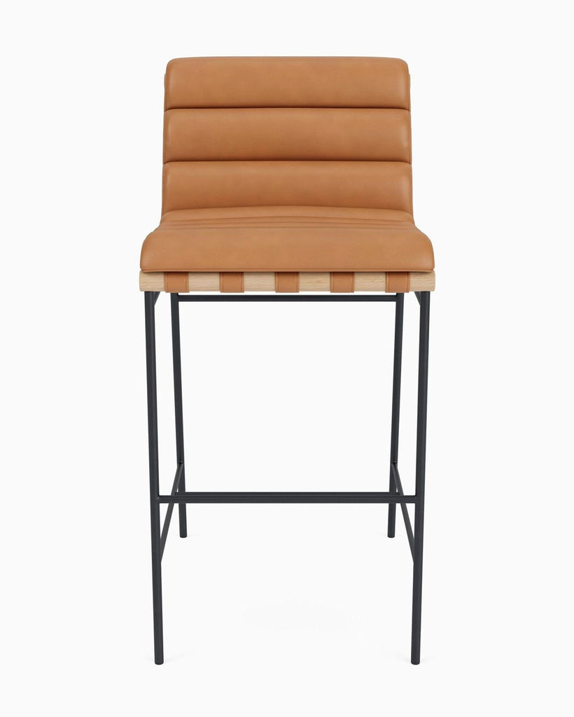 Front view of a modern bar stool from Reperch with tan ribbed leather seat and black minimalist metal frame.
