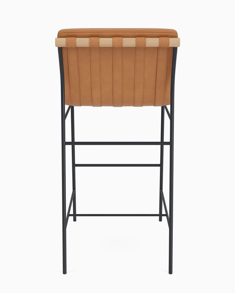 Reperch brand stool viewed from behind, highlighting the tan leather backrest and minimalist metal base.