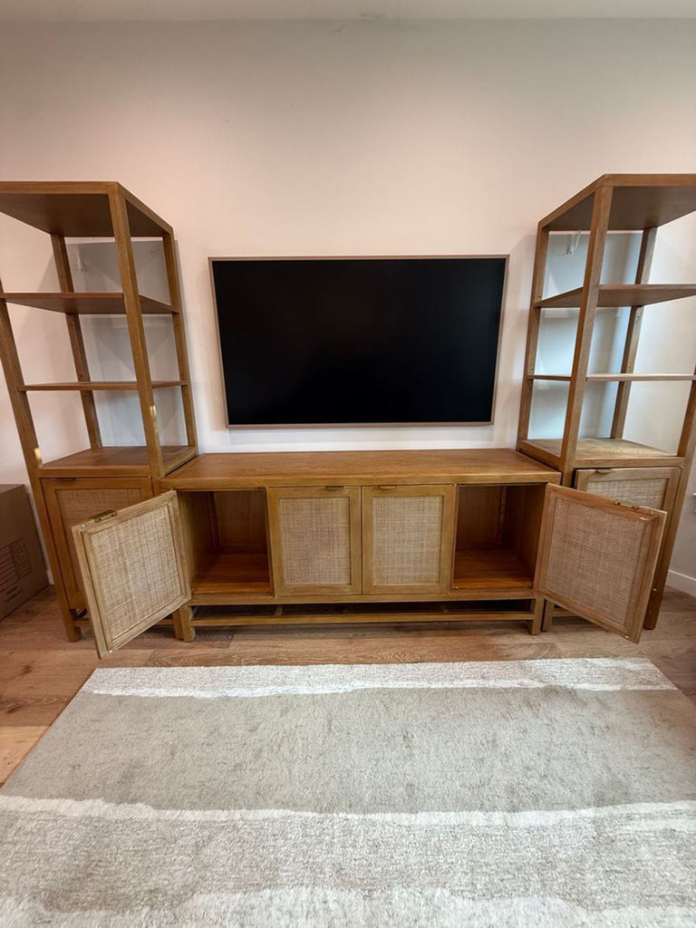 3. Crate & Barrel Entertainment Center, wood frame and woven cabinet doors, shelves on both sides, TV above.