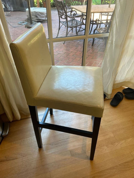 Pair of modern bar chairs with cushioned seats, displayed side by side on a plain background.  
