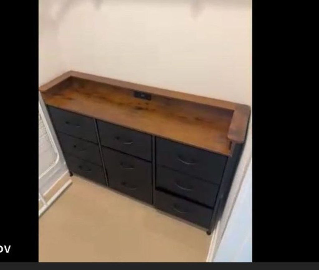 1. Black cabinet with nine drawers and wooden top, featuring a built-in electrical socket at the back.  