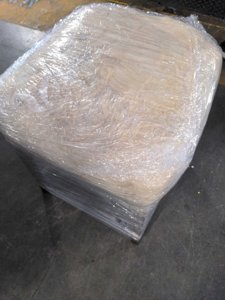 1. CB2 stool or ottoman with shaggy white cushion, wrapped securely in plastic for shipping or storage.