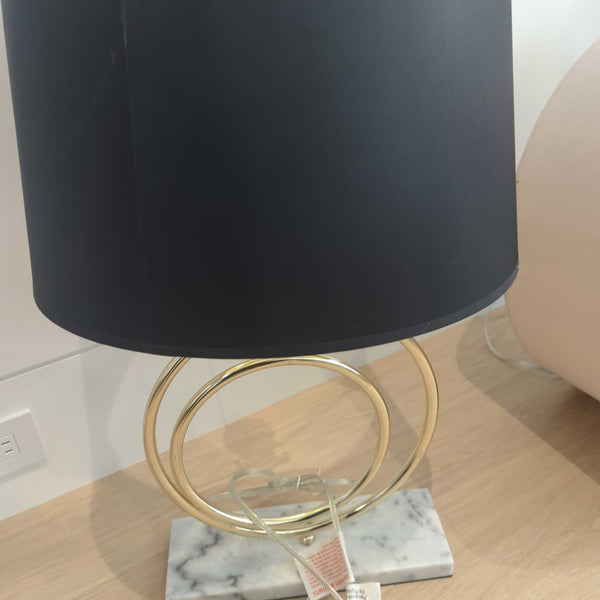 1. Table lamp with a black shade, gold circular base, and marble stand, placed on a wooden surface.