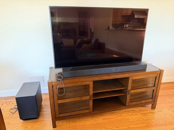 Modern TV console table with open shelves, perfect for living rooms; sleek design in dark wood tones.