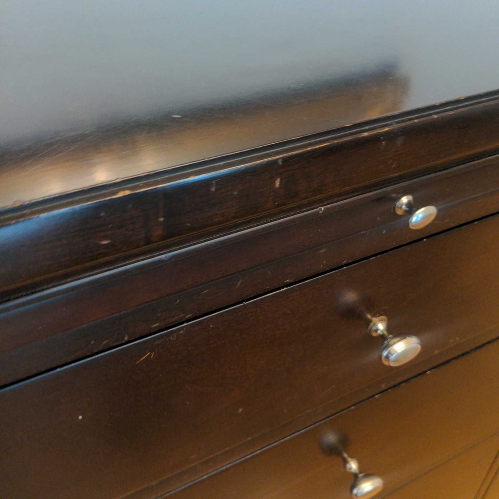 2. Close-up of the Bernhardt credenza's top surface and drawers, showing minor scuffs and metallic knobs.