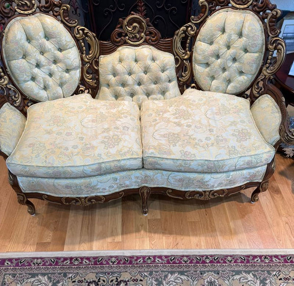 A single gray loveseat with cushioned seating and simple, modern design.