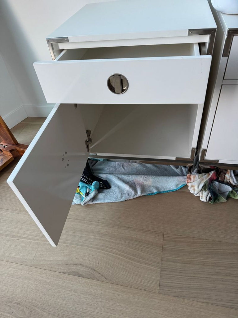 2. Open West Elm end table showing inner storage space, one drawer and a cabinet with a circular pull.