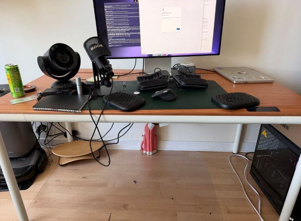 A modern standing desk with a white frame and a wood top, ideal for ergonomic office setups.