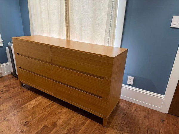 1. Greenington Bamboo Furniture dresser with six drawers, showcasing a minimalist natural bamboo finish in a modern room.  