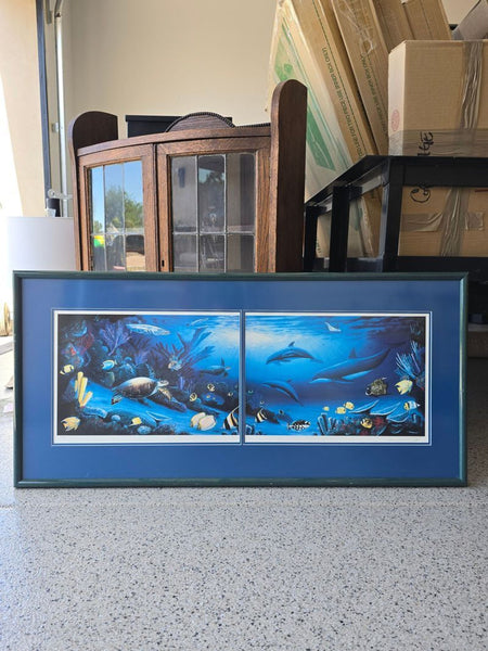 Framed print of dolphins, sea turtle, and tropical fish in a vibrant blue underwater scene with double matting.  