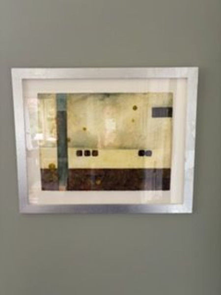 1. Framed abstract painting with geometric shapes in muted earth tones, mounted on a grey wall.