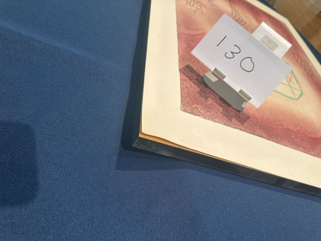 2. Close-up of abstract art print corner with number 130 card, on a blue tablecloth in a Prints & Maps setting.