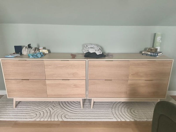 Pair of modern, fluted 4-drawer dressers in walnut finish, ideal for bedroom or living room storage.