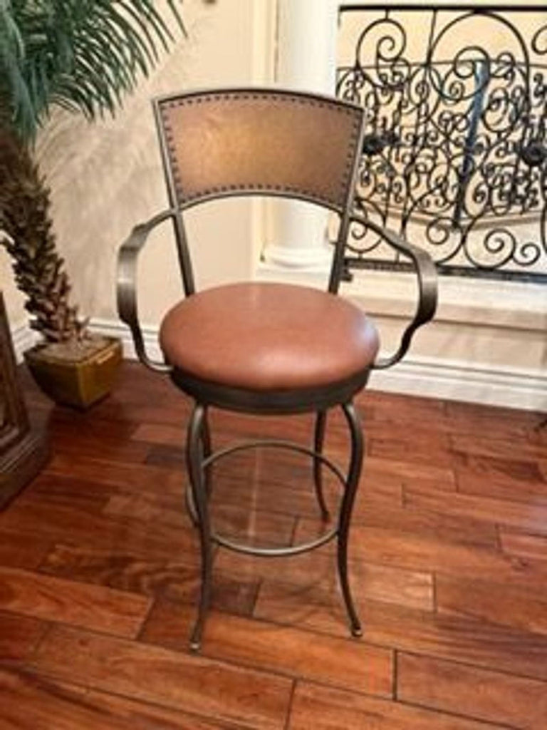 Dining chair with metal framework, brown seat and backrest, swivel function, and padded armrests.